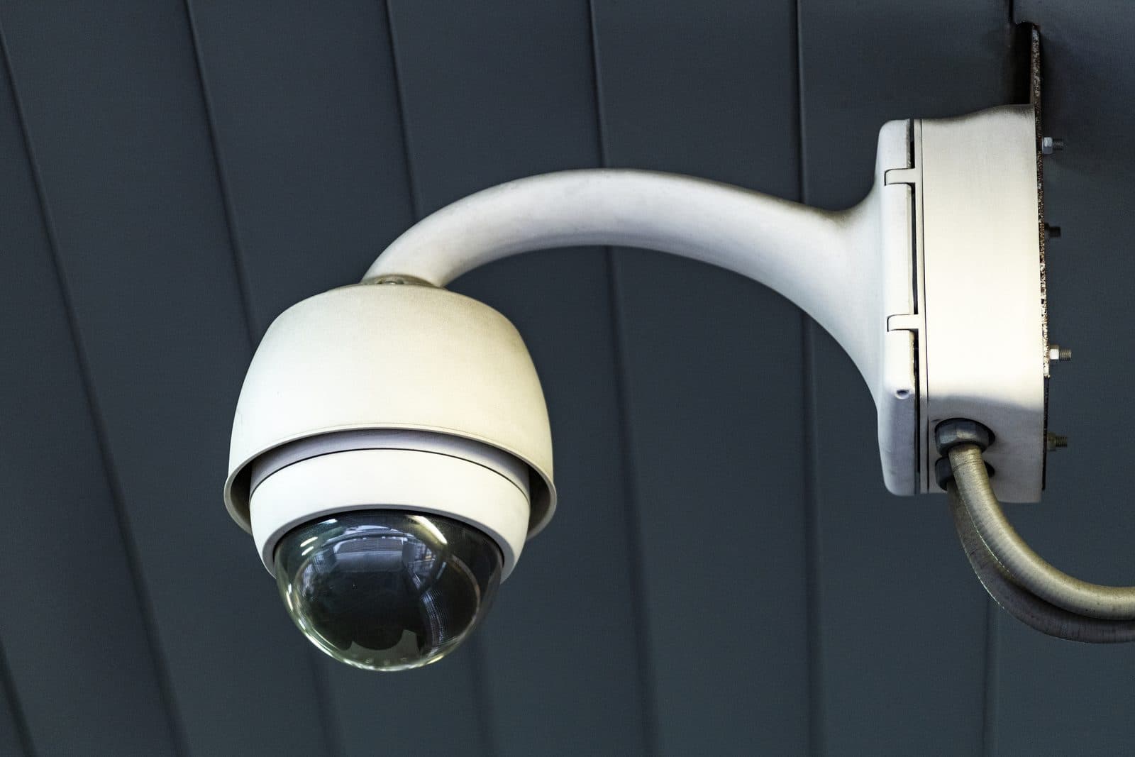 A CCTV dome camera mounted on a ceiling