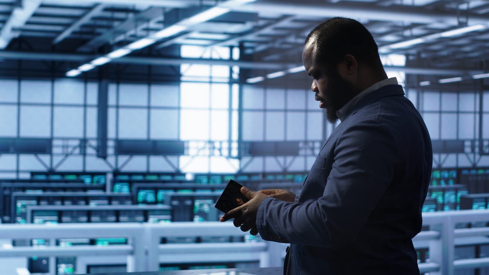 A system administrator installing a storage unit in a server room